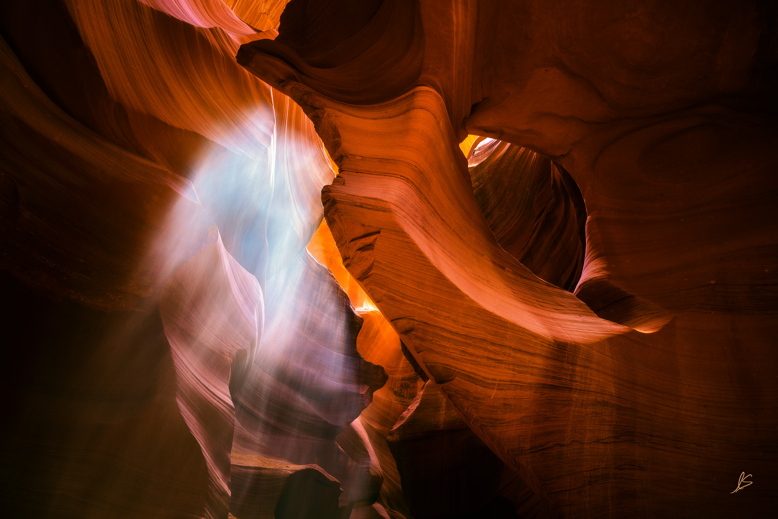 A ghostly apparition becomes visible as sand falling into Lower Antelope Canyon is illuminated by a ray of sun piercing into...